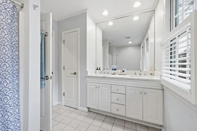 a bathroom with a double vanity sink and a mirror
