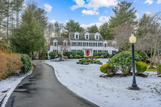 a front view of a house with garden and porch