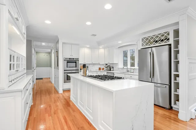 a kitchen with refrigerator a sink and a stove top oven
