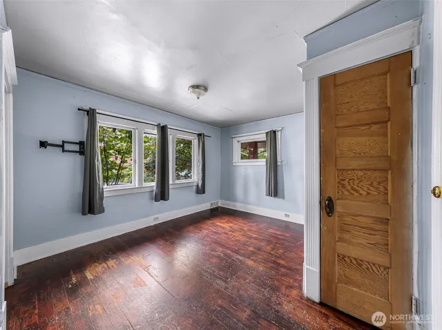 wooden floor in an empty room with a window