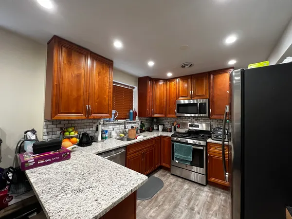 a kitchen with a refrigerator sink and stove