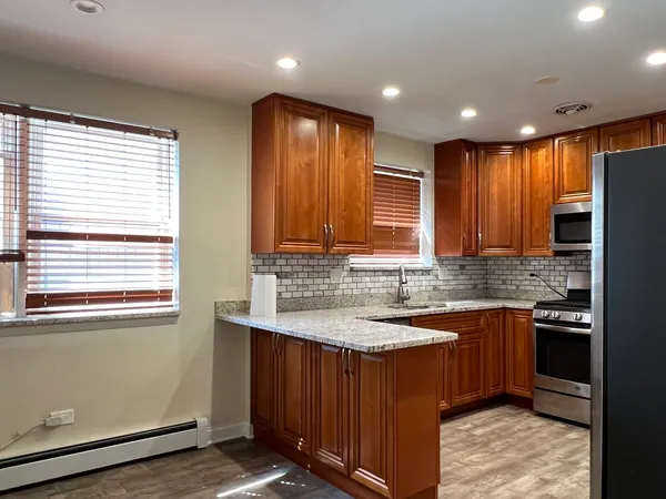 a kitchen with stainless steel appliances granite countertop wooden cabinets a sink and dishwasher