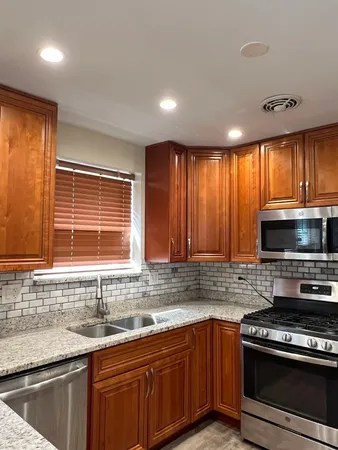 a kitchen with a sink stove top oven and cabinets