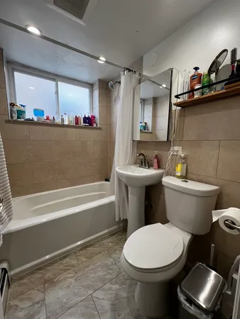 a bathroom with a toilet a sink and bathtub