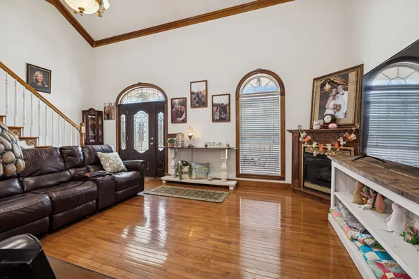 a living room with fireplace furniture and wooden floor