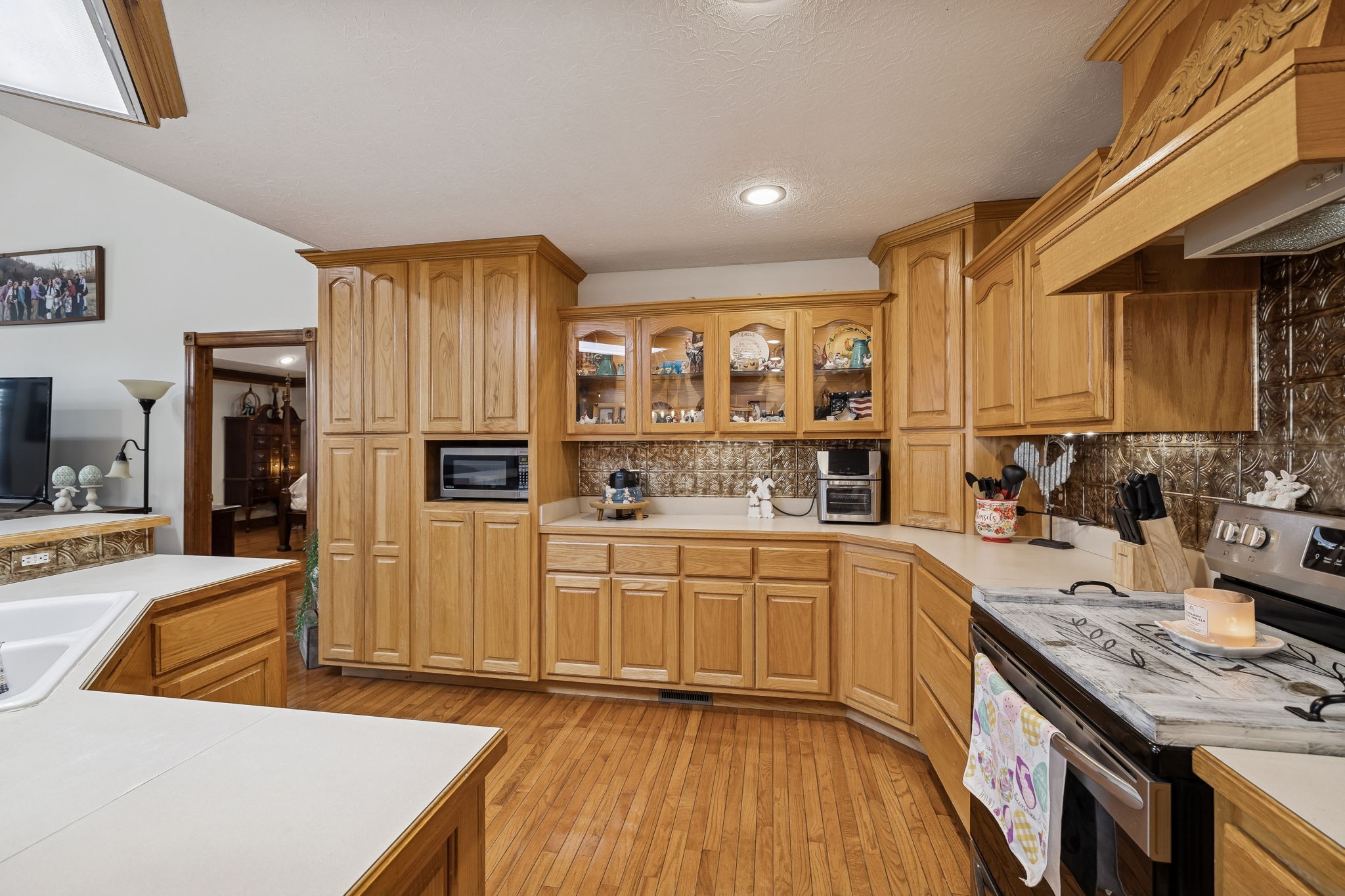 389 Trace Creek Road Red Boiling Springs, TN 37150 - Photo 17 of 57 a kitchen with stainless steel appliances granite countertop a sink dishwasher stove and refrigerator with wooden floor