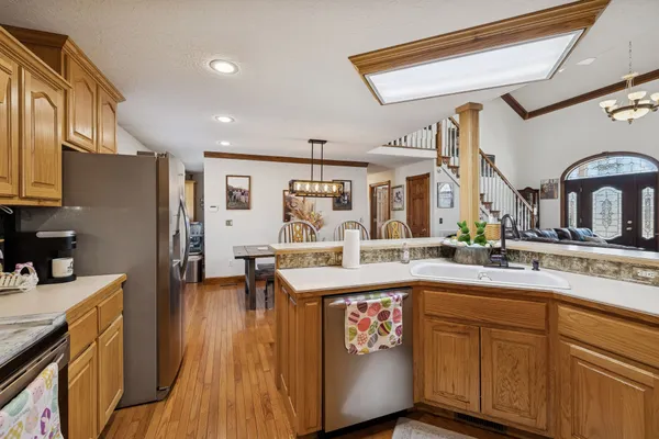 a kitchen with stainless steel appliances granite countertop a sink stove and refrigerator