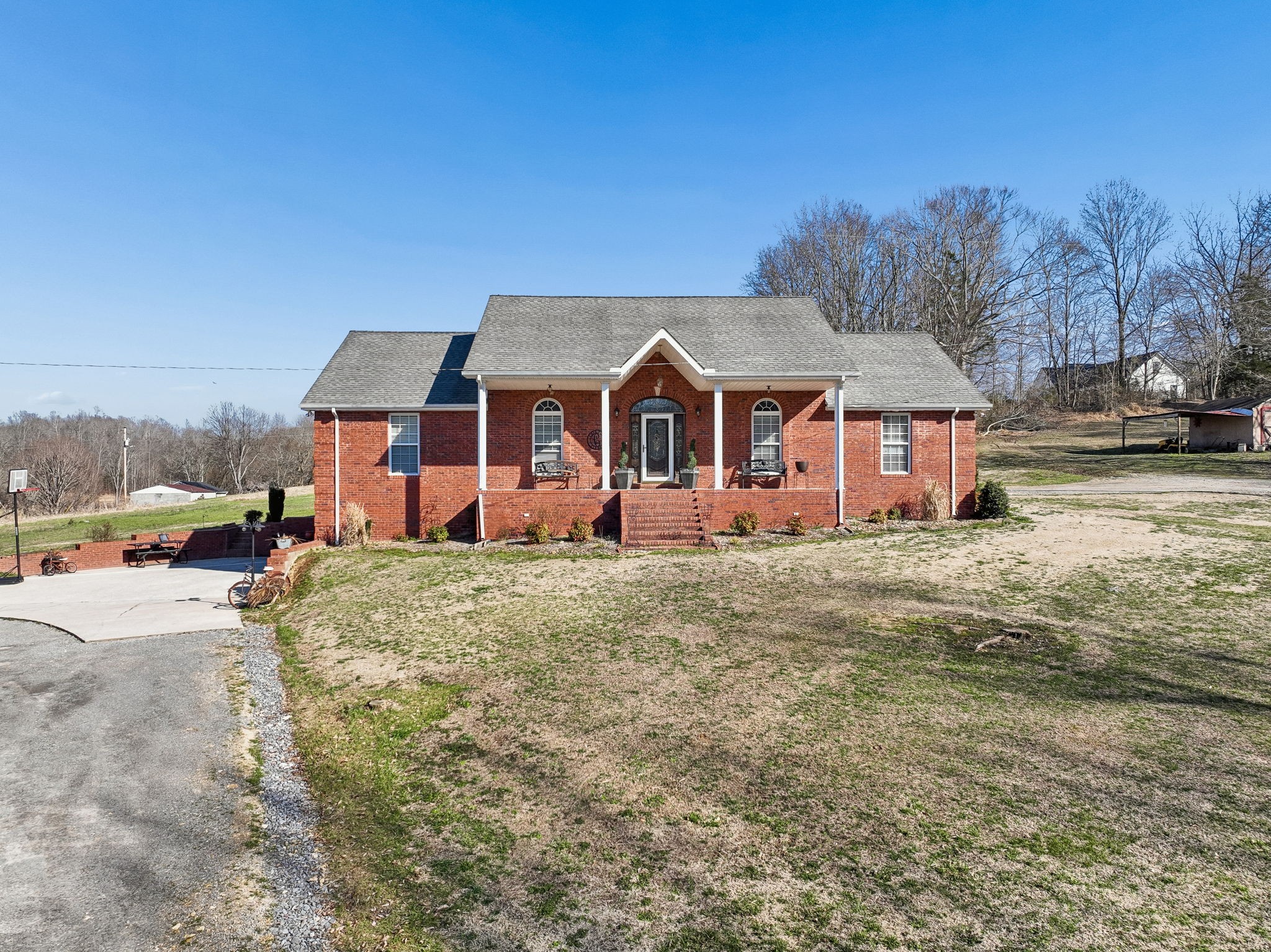 389 Trace Creek Road Red Boiling Springs, TN 37150 - Photo 3 of 57 a view of a big house with a big yard and large trees