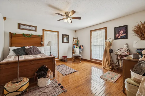 an empty room with wooden floor chandelier fan and closet in a room