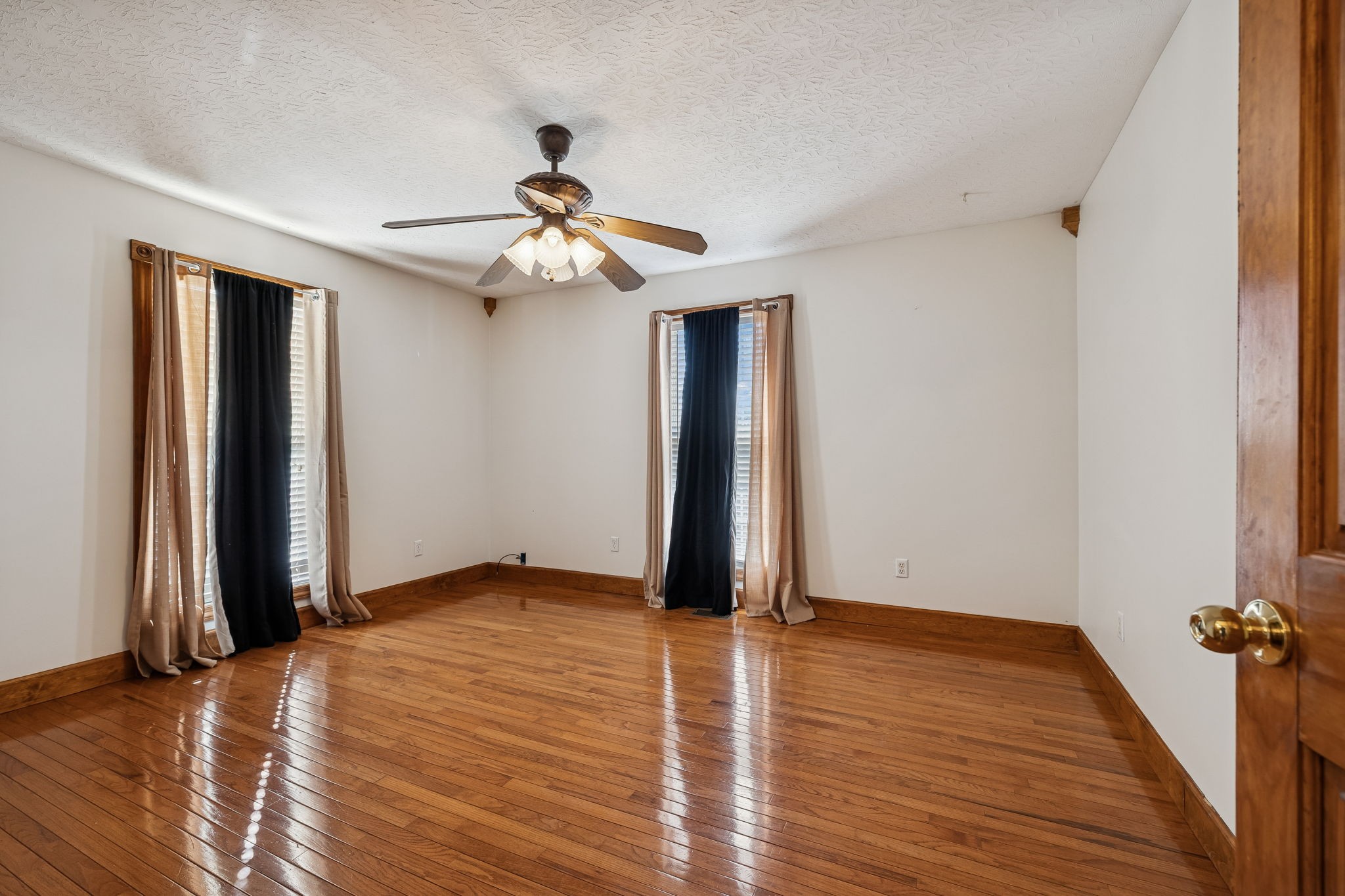 389 Trace Creek Road Red Boiling Springs, TN 37150 - Photo 33 of 57 an empty room with wooden floor chandelier fan and closet in a room