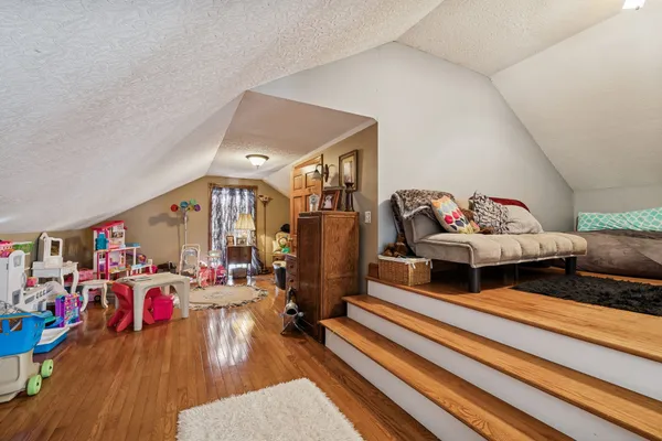 a living room with furniture flowerpot and a rug