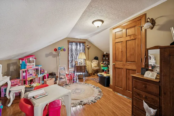 a bedroom with furniture and a wooden floor
