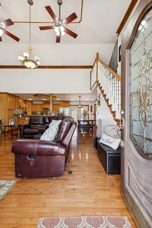 a view of a livingroom with wooden floor and furniture