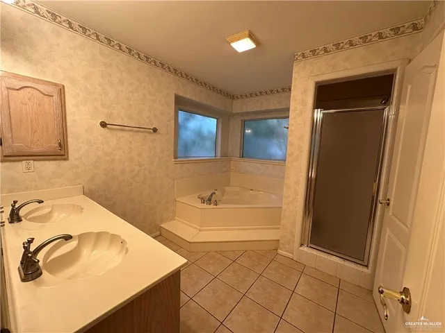 a bathroom with a tub sink and a mirror