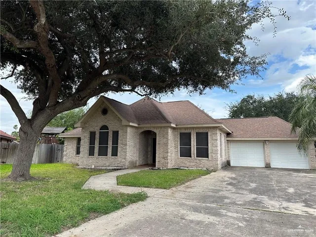 a front view of a house with a garden and yard
