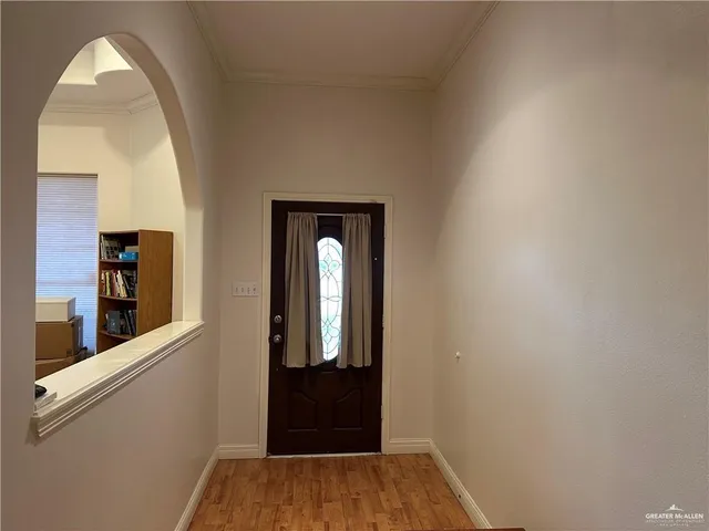 a view of a hallway with wooden floor