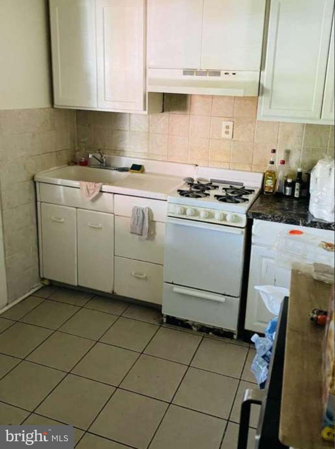 186 West Hanover Street Trenton, NJ 08618 - Photo 7 of 10 a kitchen with a stove a sink and a refrigerator