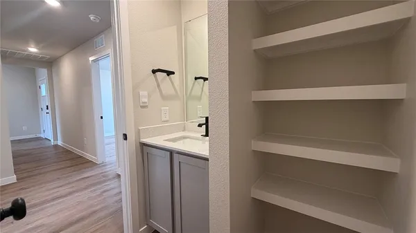 a view of bathroom with a sink and mirror