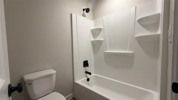 a bathroom with a bathtub a toilet and a shower