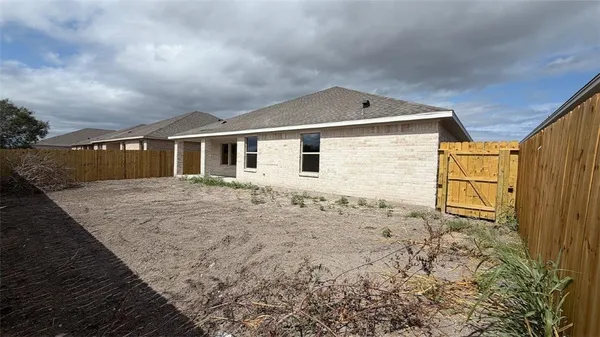 a view of house with backyard