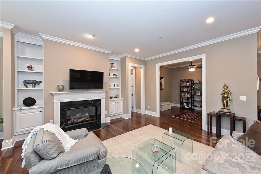 3240 Park Road Charlotte, NC 28209 - Photo 12 of 39 a living room with furniture a flat screen tv and a fireplace