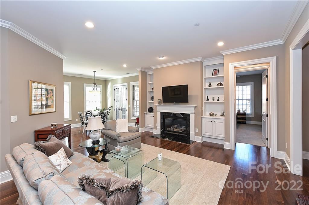 3240 Park Road Charlotte, NC 28209 - Photo 16 of 39 a living room with furniture a fireplace and a wooden floor