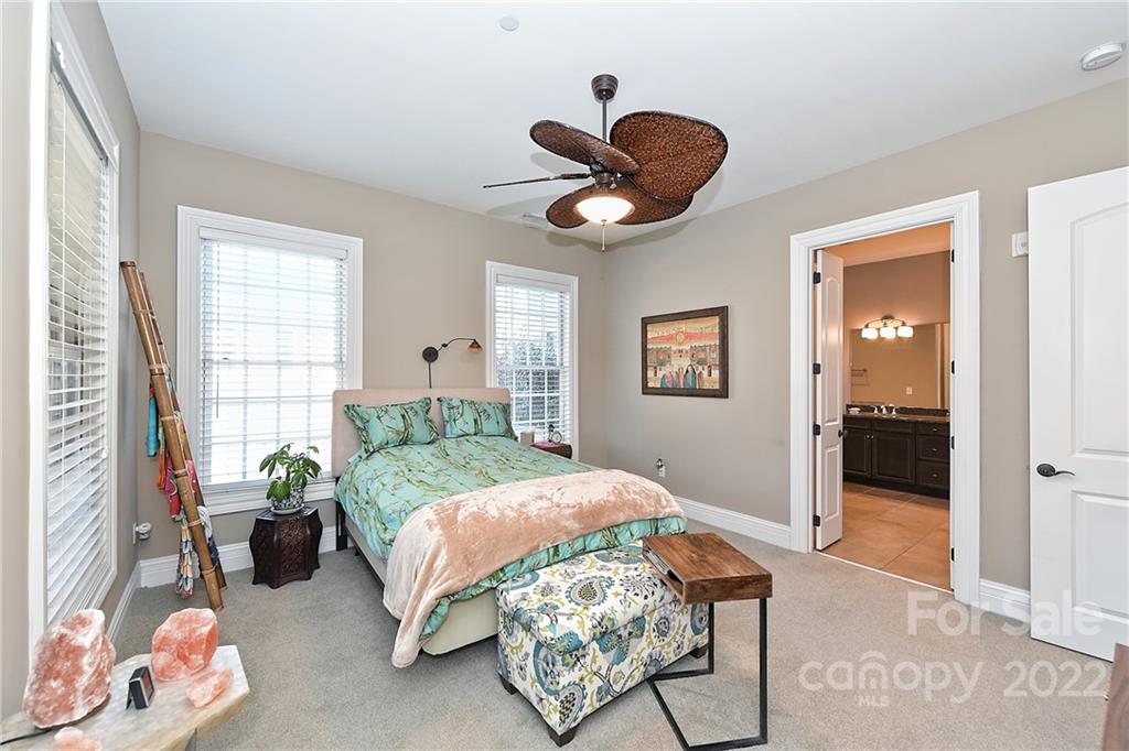 3240 Park Road Charlotte, NC 28209 - Photo 23 of 39 a bedroom with a bed and a chandelier