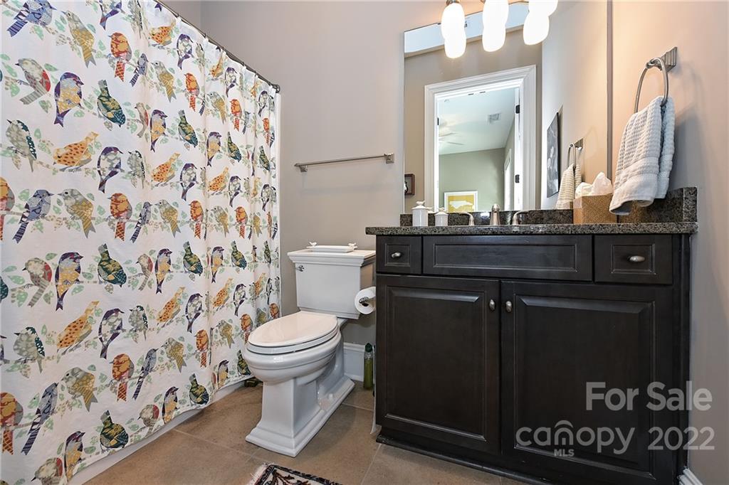 3240 Park Road Charlotte, NC 28209 - Photo 28 of 39 a bathroom with a granite countertop toilet sink and mirror