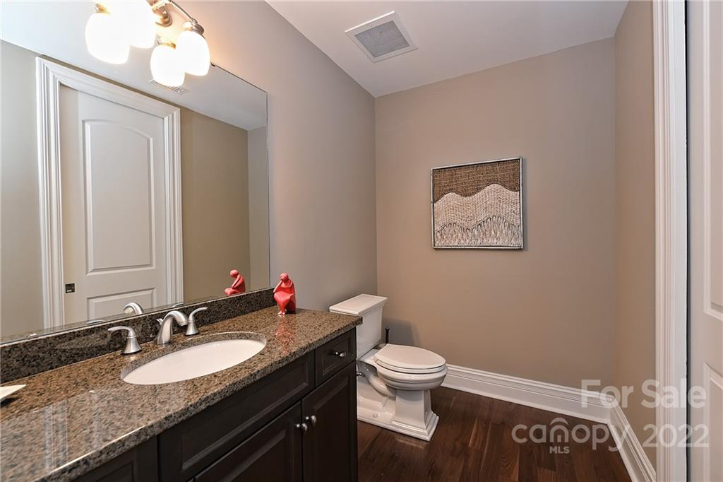 3240 Park Road Charlotte, NC 28209 - Photo 29 of 39 a bathroom with a granite countertop sink vanity mirror and toilet