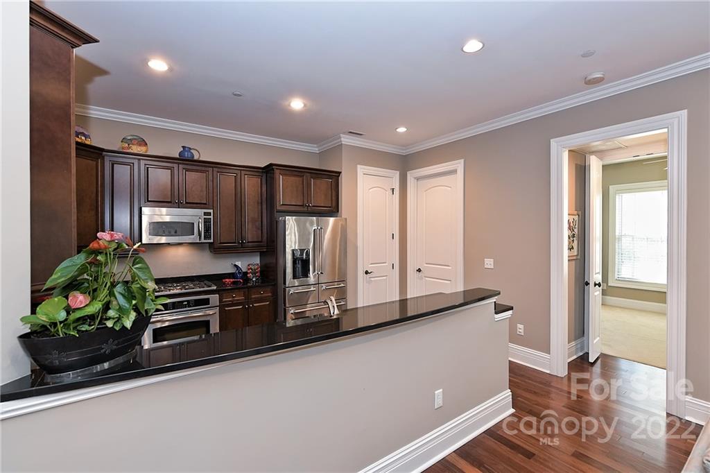 3240 Park Road Charlotte, NC 28209 - Photo 5 of 39 a kitchen with stainless steel appliances a refrigerator and a stove top oven