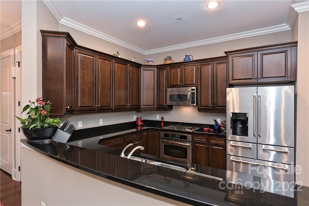 3240 Park Road Charlotte, NC 28209 - Photo 6 of 39 a kitchen with stainless steel appliances granite countertop a sink a stove and a refrigerator
