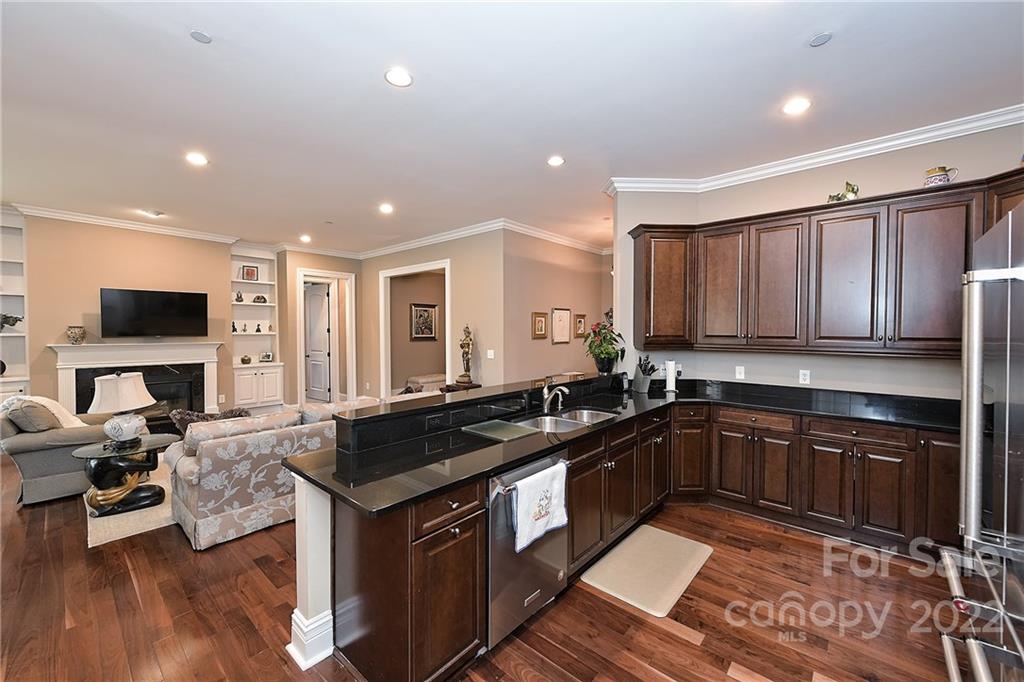3240 Park Road Charlotte, NC 28209 - Photo 9 of 39 a kitchen with granite countertop a sink stove and cabinets