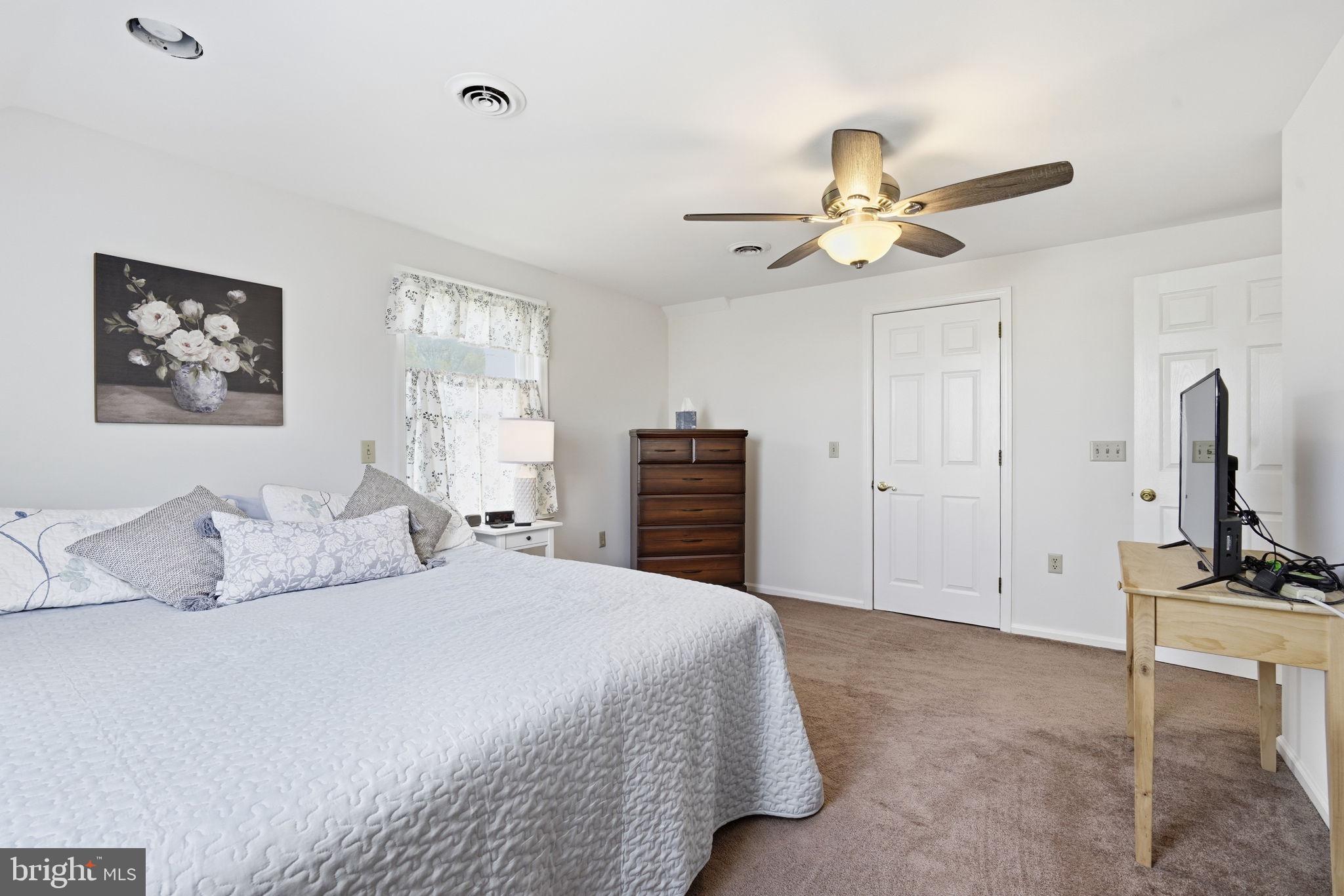 12089 Blacks Station Road Kennedyville, MD 21645 - Photo 25 of 39 a bedroom with a bed and a chandelier