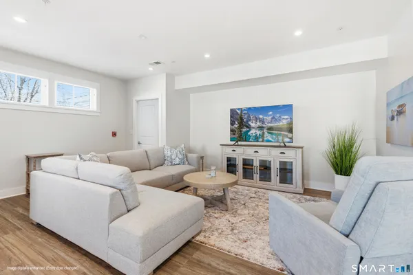 a living room with furniture and a potted plant