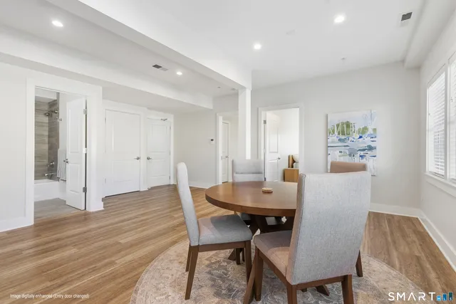 a view of a dining room with furniture and wooden floor