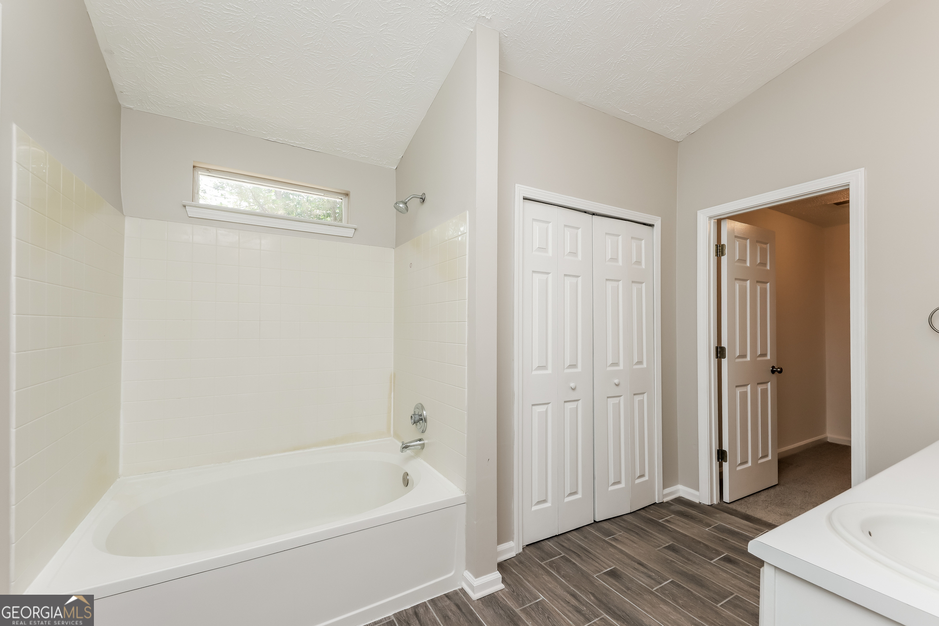 9945 Rivercliff Lane Villa Rica, GA 30180 - Photo 12 of 17 a bathroom with a tub shower and sink