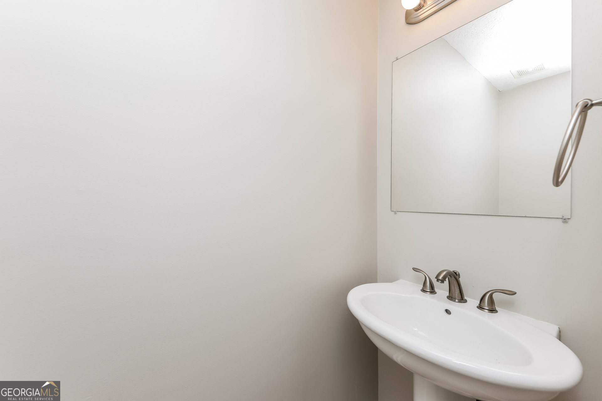 9945 Rivercliff Lane Villa Rica, GA 30180 - Photo 13 of 17 a bathroom with a sink and a mirror