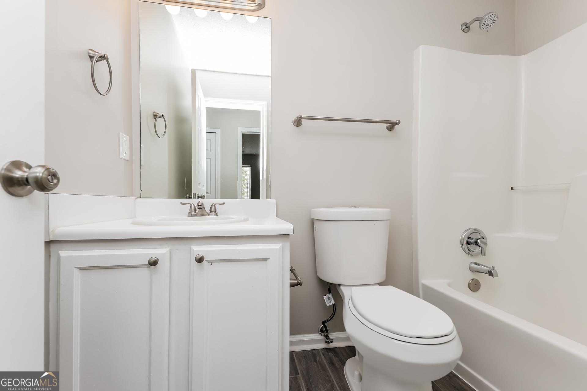9945 Rivercliff Lane Villa Rica, GA 30180 - Photo 14 of 17 a bathroom with a sink a toilet a mirror and shower