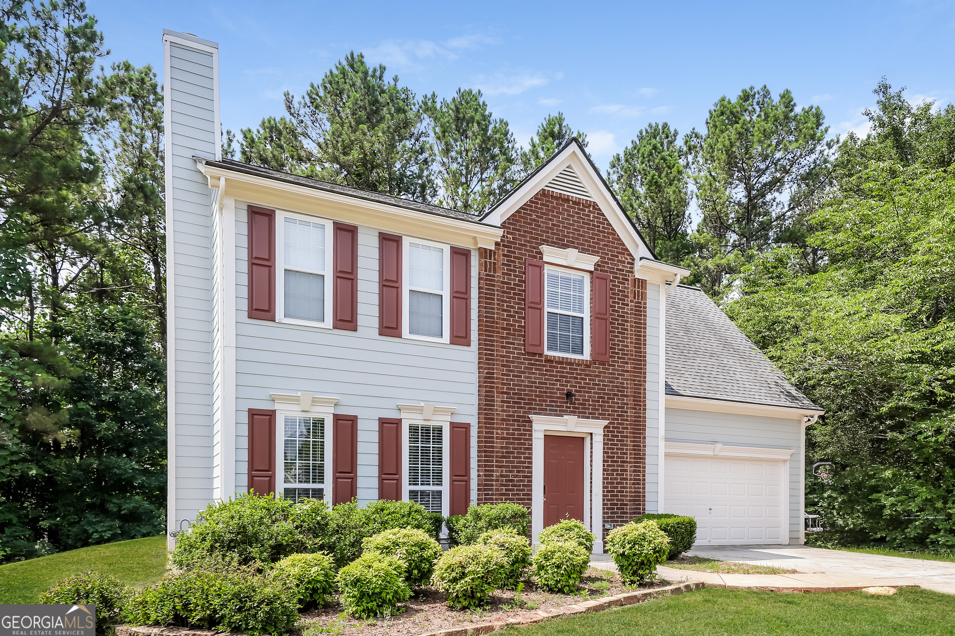 9945 Rivercliff Lane Villa Rica, GA 30180 - Photo 2 of 17 a front view of a house with garden