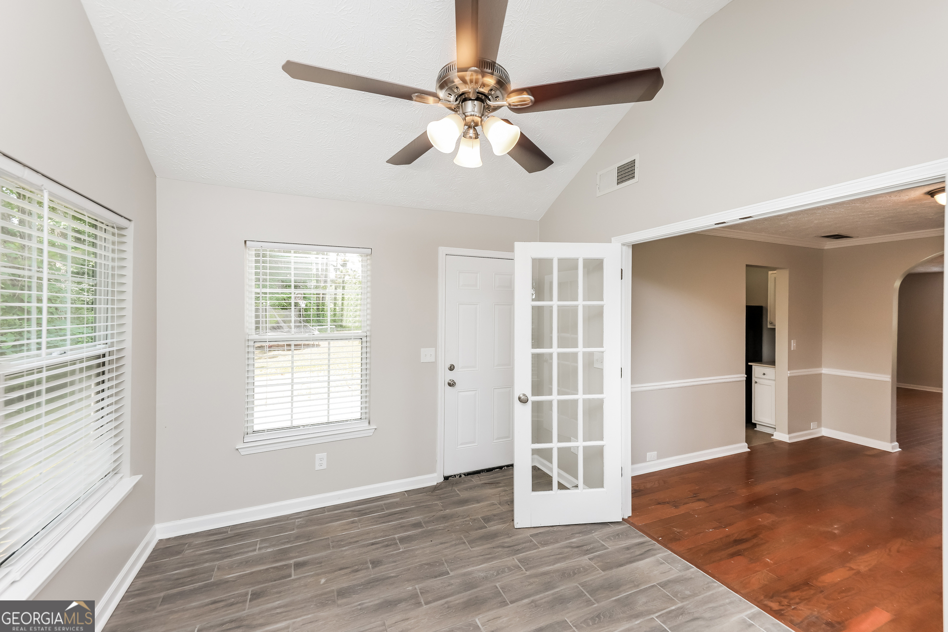 9945 Rivercliff Lane Villa Rica, GA 30180 - Photo 8 of 17 a view of an empty room with wooden floor and a window