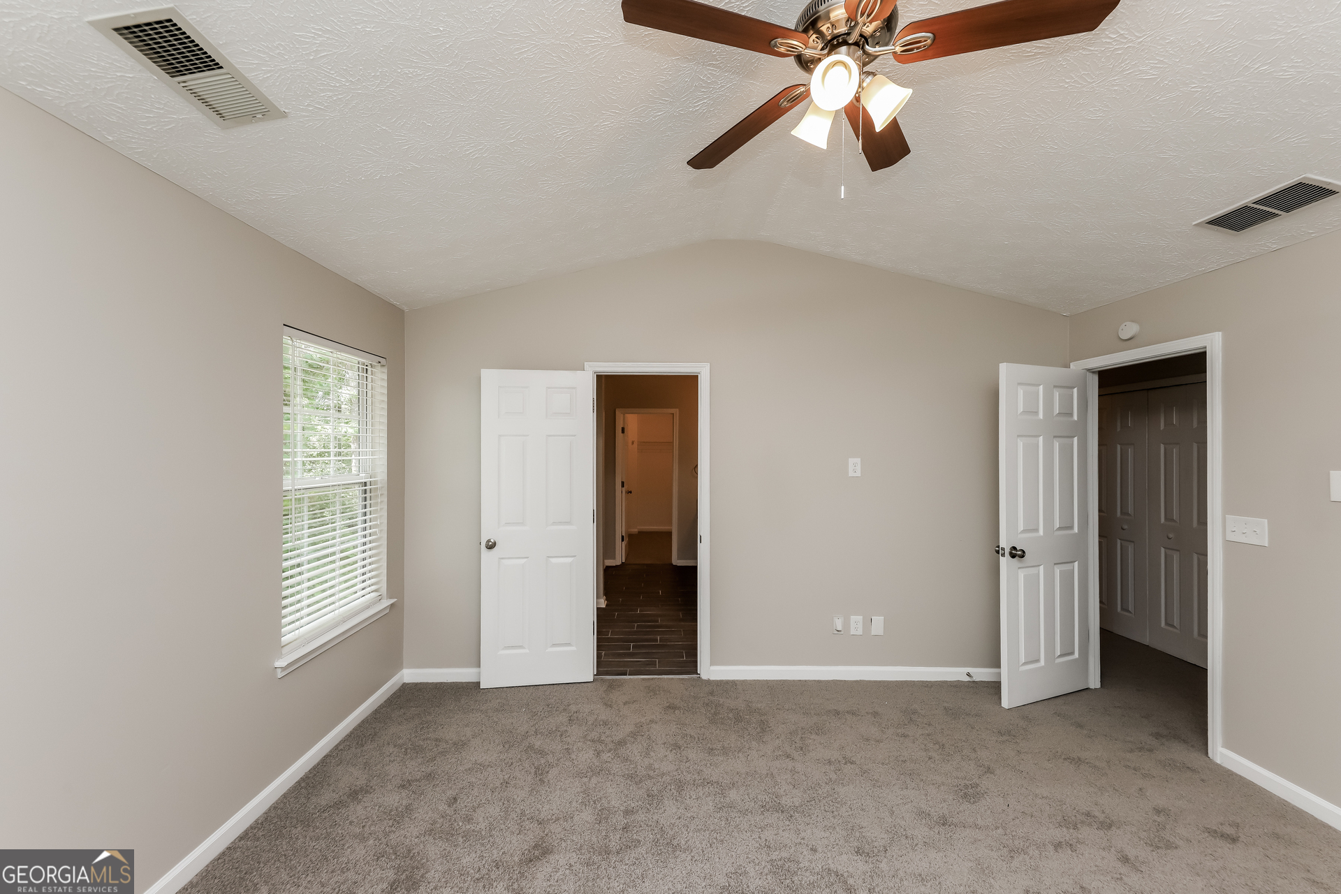 9945 Rivercliff Lane Villa Rica, GA 30180 - Photo 9 of 17 an empty room with closet and fan
