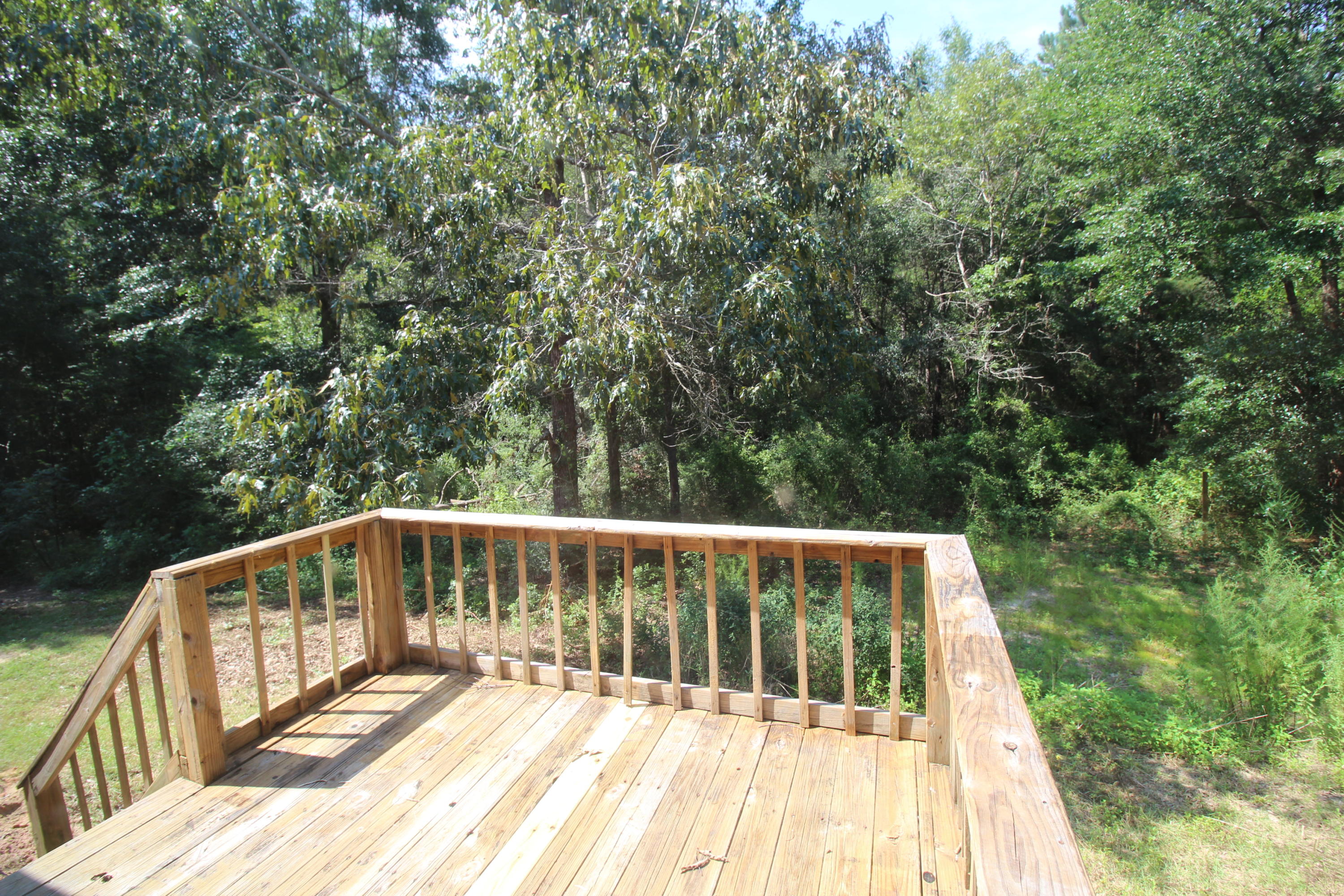 3935 Bambi Road Crestview, FL 32539 - Photo 18 of 21 a view of balcony with wooden floor and fence
