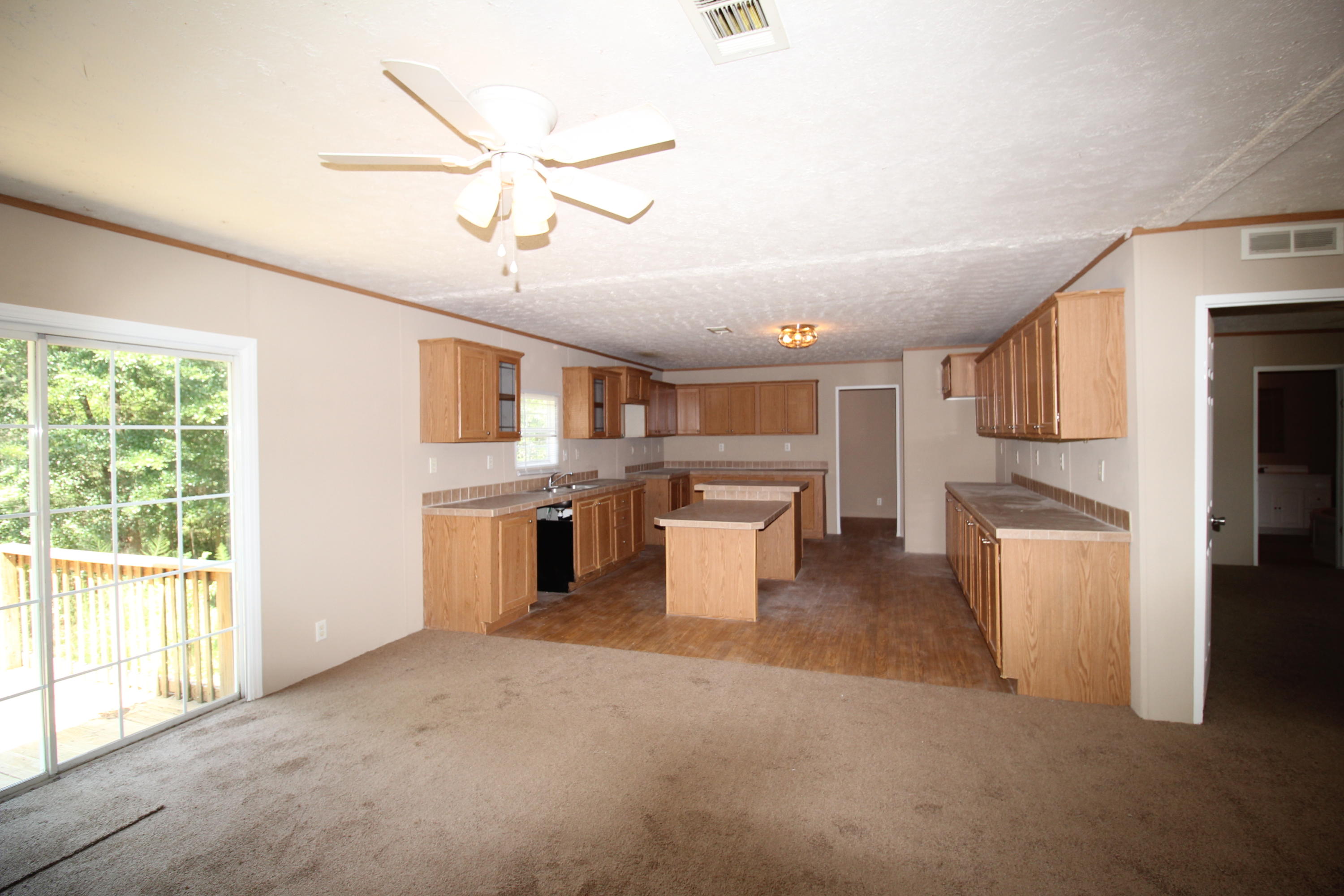 3935 Bambi Road Crestview, FL 32539 - Photo 4 of 21 a large white kitchen with a window and stainless steel appliances