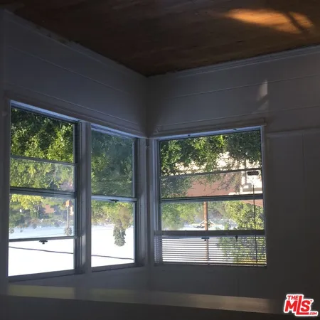 a view of a room that has a large window