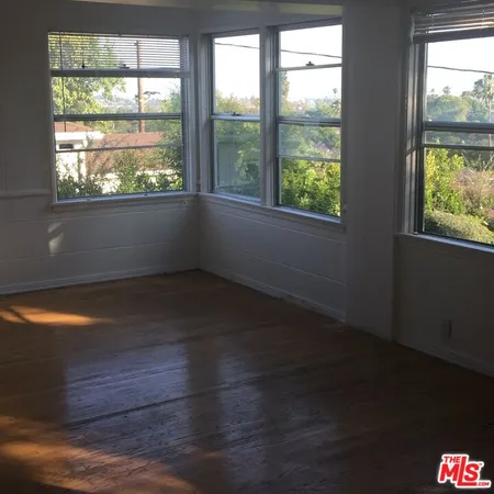 a room with a sink and large window