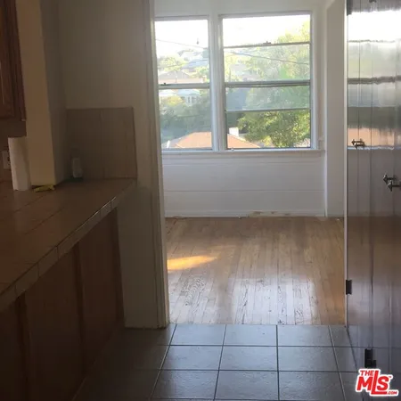 a bathroom with a sink a toilet and a window