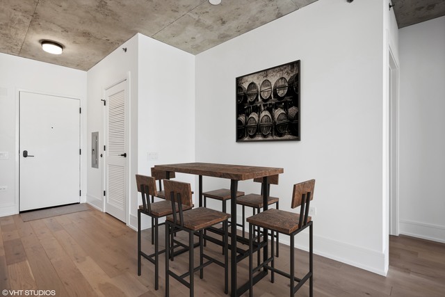 234 West Polk Street, Unit 2610 Chicago, IL 60605 - Photo 13 of 36 a view of a dining room with furniture and wooden floor