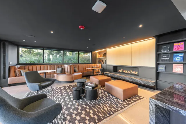 a living room with furniture a rug and a projector