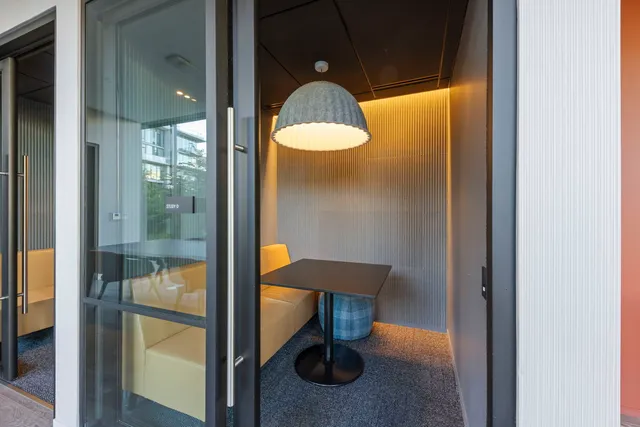 a living room with furniture a flat screen tv and kitchen view