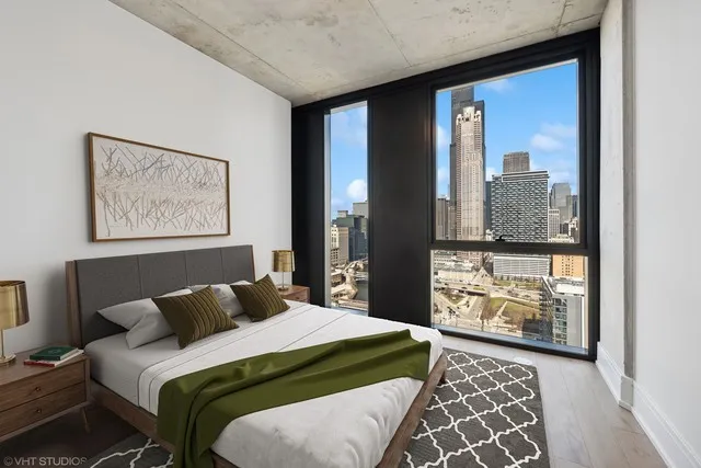 a bedroom with a large bed and a window